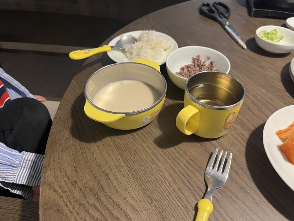 Non-spicy gomtang broth, rice and cut beef in a child's bowl, Seoul
