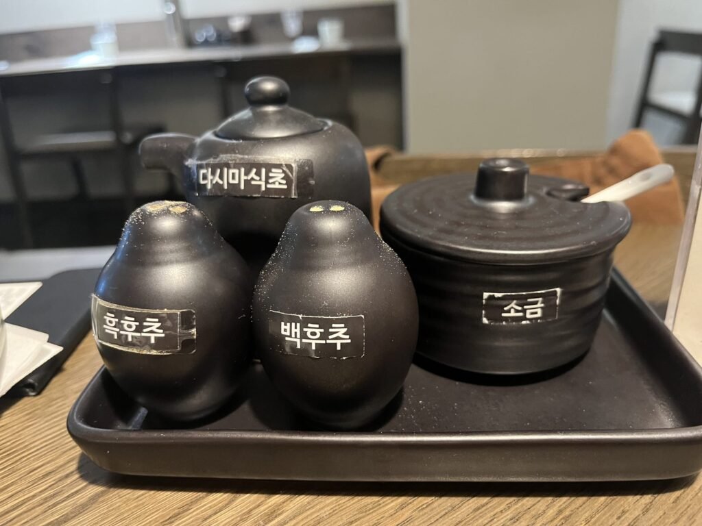 Salt and pepper jars labeled in Korean
